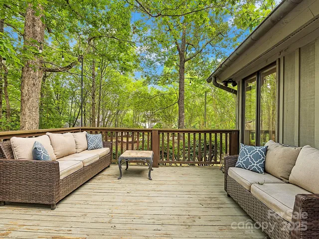 a balcony with furniture and wooden floor