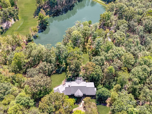 an aerial view of a house with a lake view
