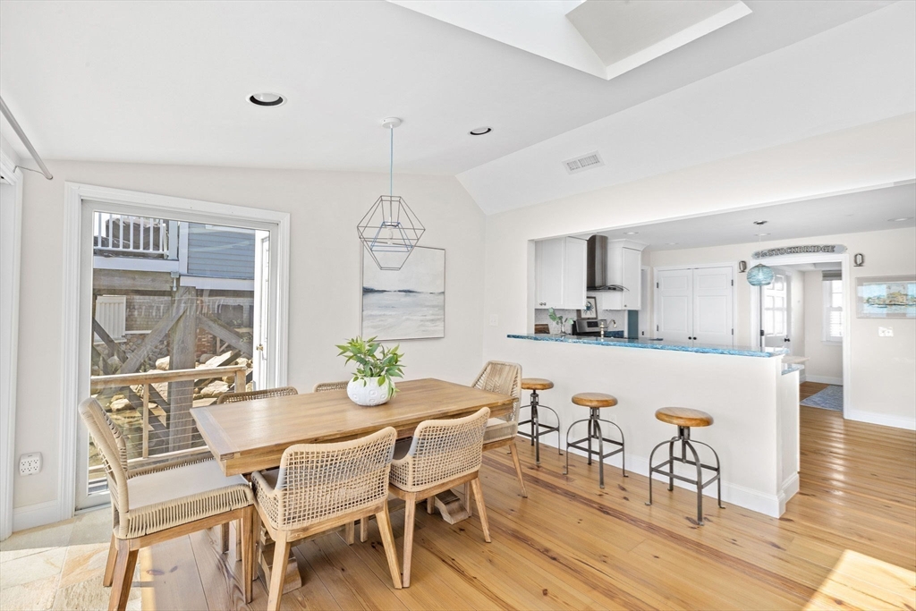 30 Lighthouse Road Scituate, MA 02066 - Photo 13 of 36 a dining room with furniture a chandelier and wooden floor