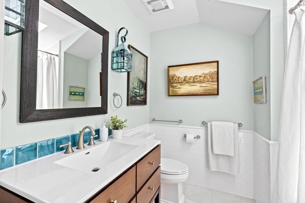 30 Lighthouse Road Scituate, MA 02066 - Photo 29 of 36 a bathroom with a sink a toilet and mirror