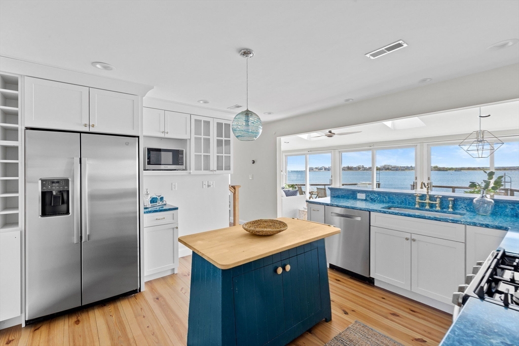 30 Lighthouse Road Scituate, MA 02066 - Photo 10 of 36 a kitchen with stainless steel appliances granite countertop a refrigerator a sink dishwasher a stove with white cabinets and wooden floor