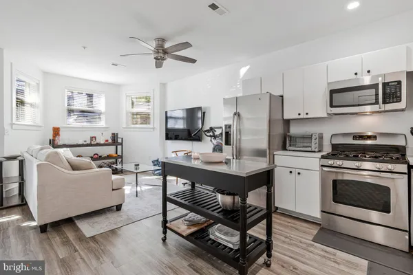 a kitchen with stainless steel appliances a stove a refrigerator and a sink