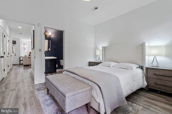 a spacious bedroom with a bed and a walk in closet