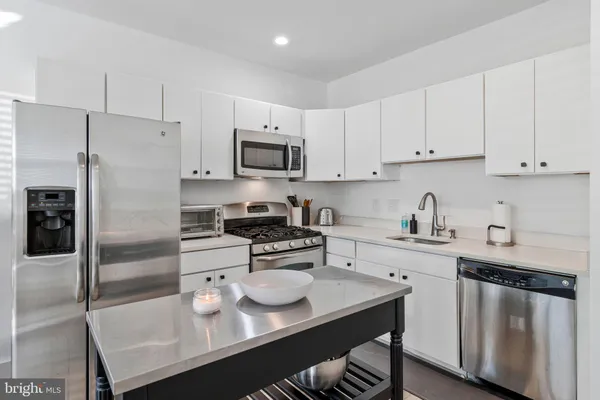 a kitchen with a sink a stove and refrigerator