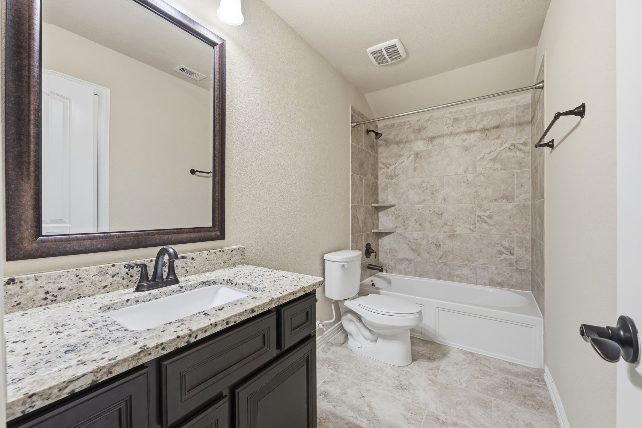 25210 Gaddis Oaks Drive Spring, TX 77389 - Photo 36 of 50 a bathroom with a granite countertop sink a toilet and shower