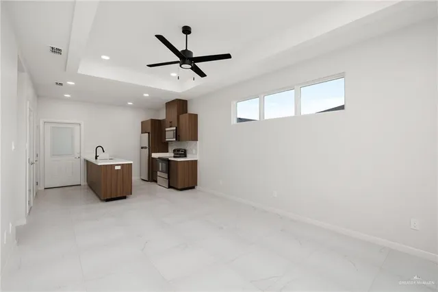 a kitchen with stainless steel appliances a refrigerator and microwave