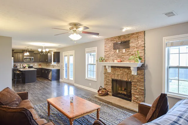 a living room with furniture and a fireplace