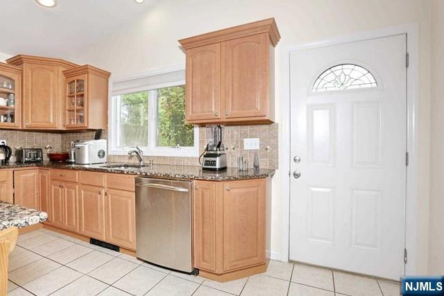 84 12th Street Cresskill, NJ 07626 - Photo 22 of 45 a kitchen with stainless steel appliances granite countertop a refrigerator a sink dishwasher and wooden cabinets