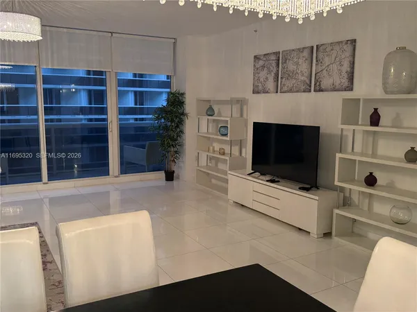 a living room with furniture flat screen tv and a fireplace