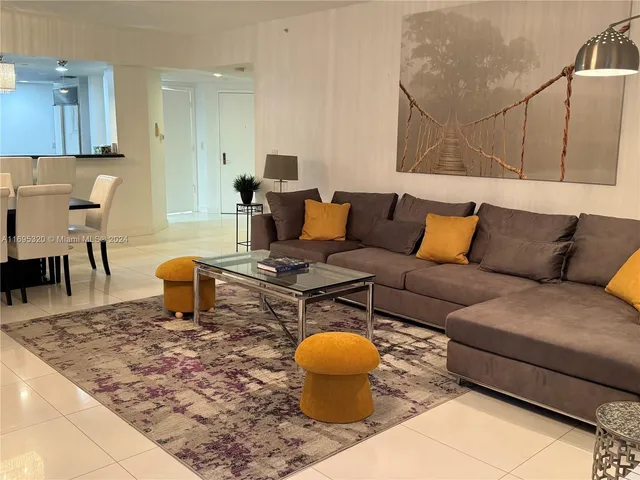 a living room with furniture and a rug