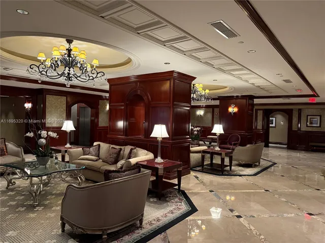 a living room with furniture a chandelier and a fireplace