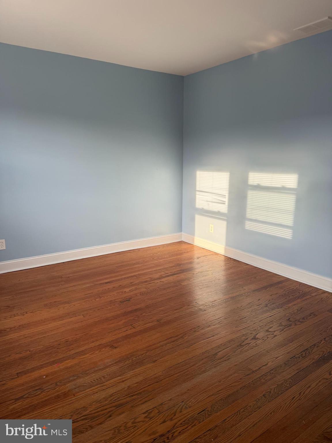 5119 2nd Street Northwest, Unit 4 Washington, DC 20011 - Photo 5 of 6 an empty room with wooden floor and windows