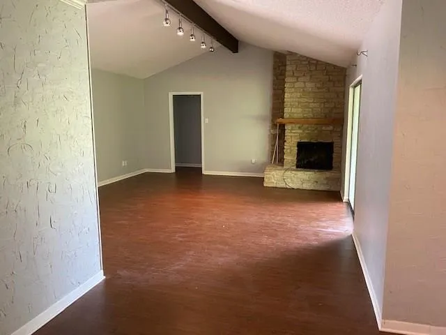 an empty room with a fireplace