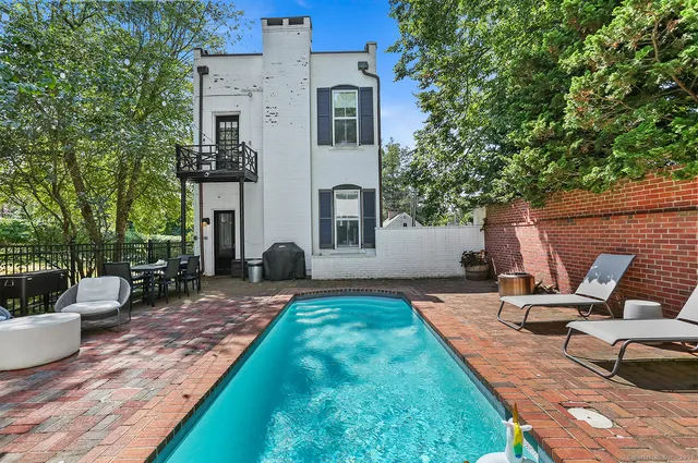 a view of a house with backyard and sitting area