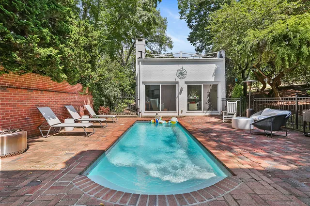 swimming pool view with a seating space