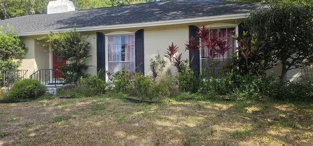 a front view of a house with garden