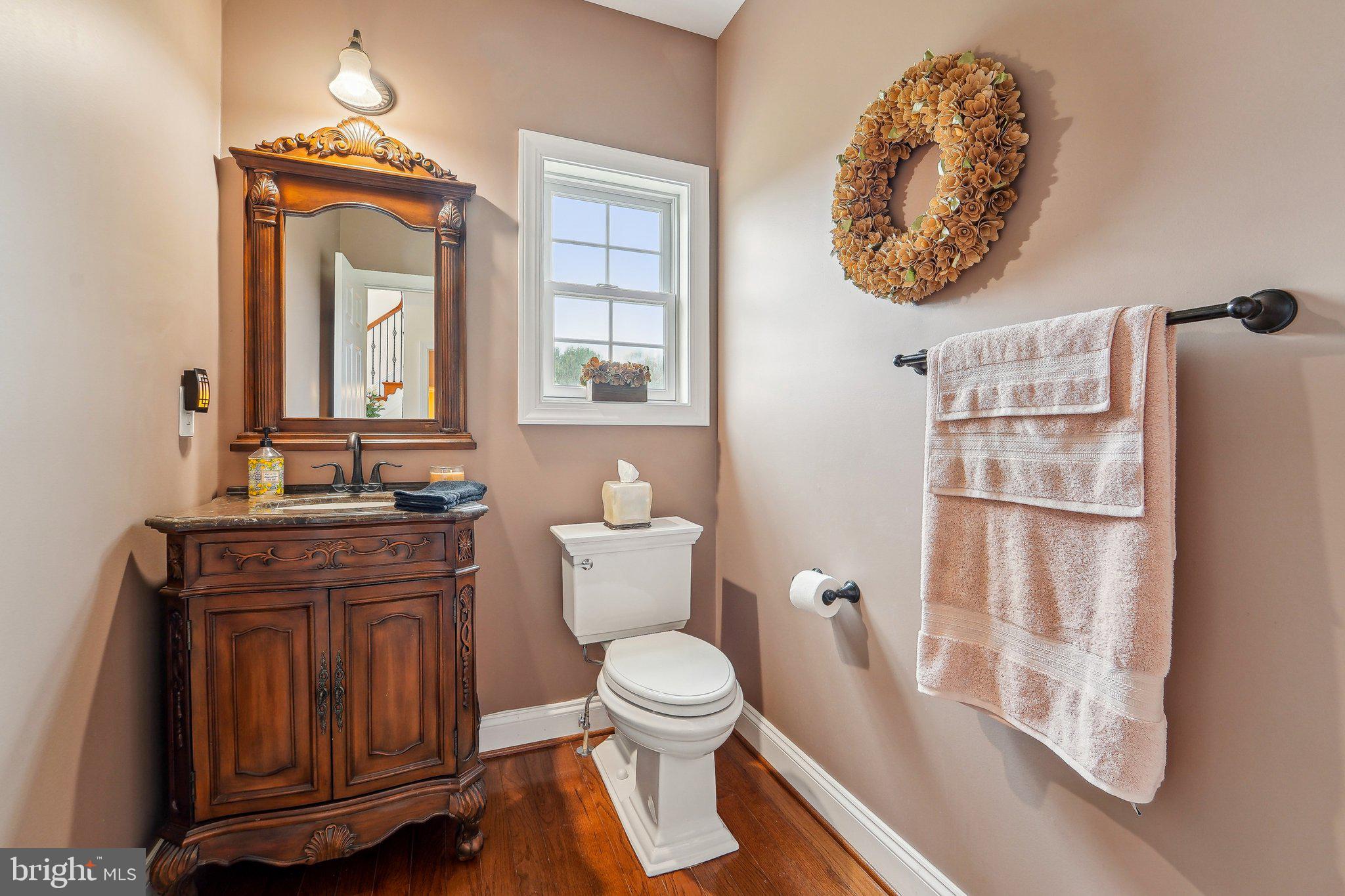 13936 Rover Mill Road West Friendship, MD 21794 - Photo 17 of 73 a bathroom with a toilet a sink and a mirror