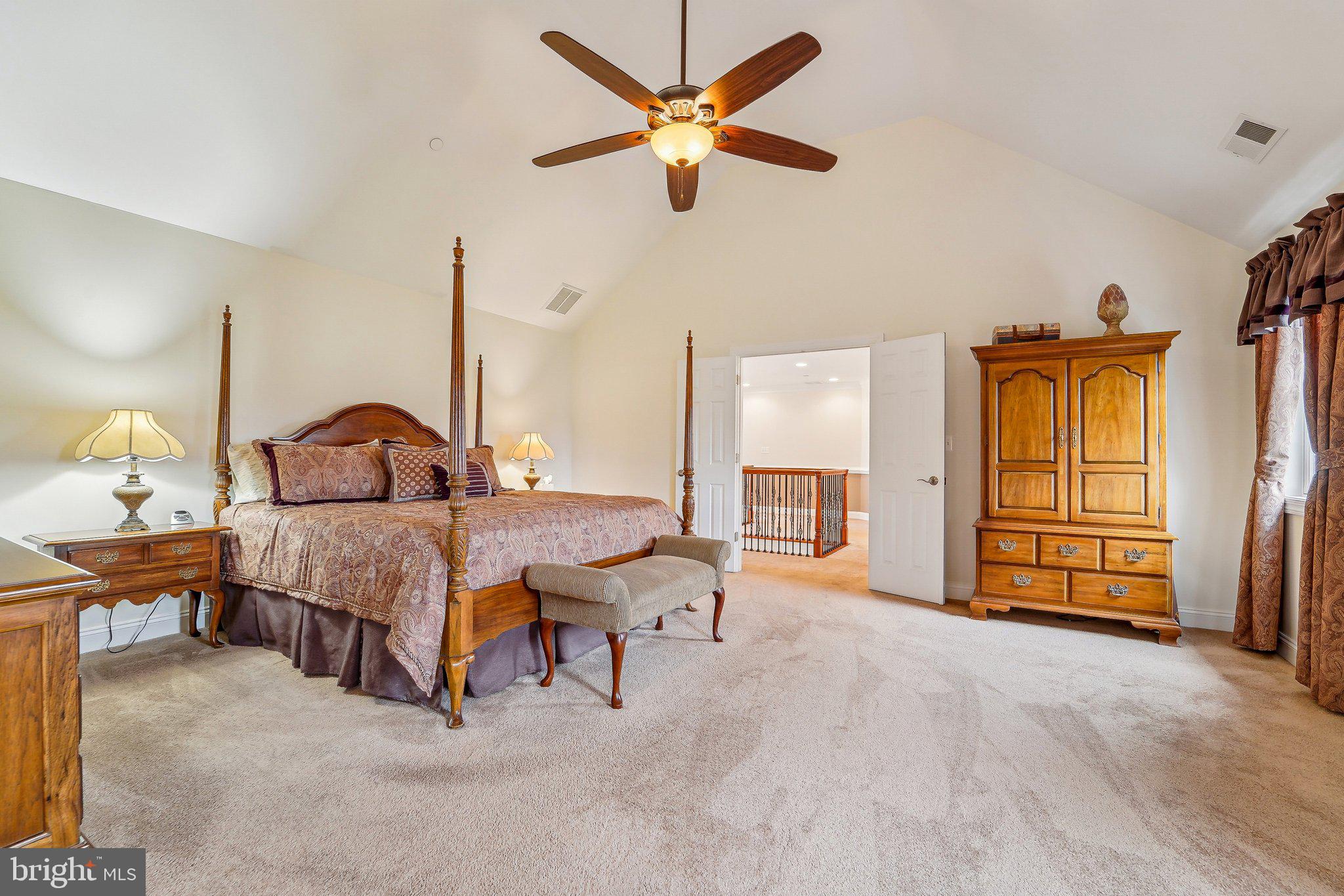 13936 Rover Mill Road West Friendship, MD 21794 - Photo 19 of 73 a bedroom with a bed and a chandelier
