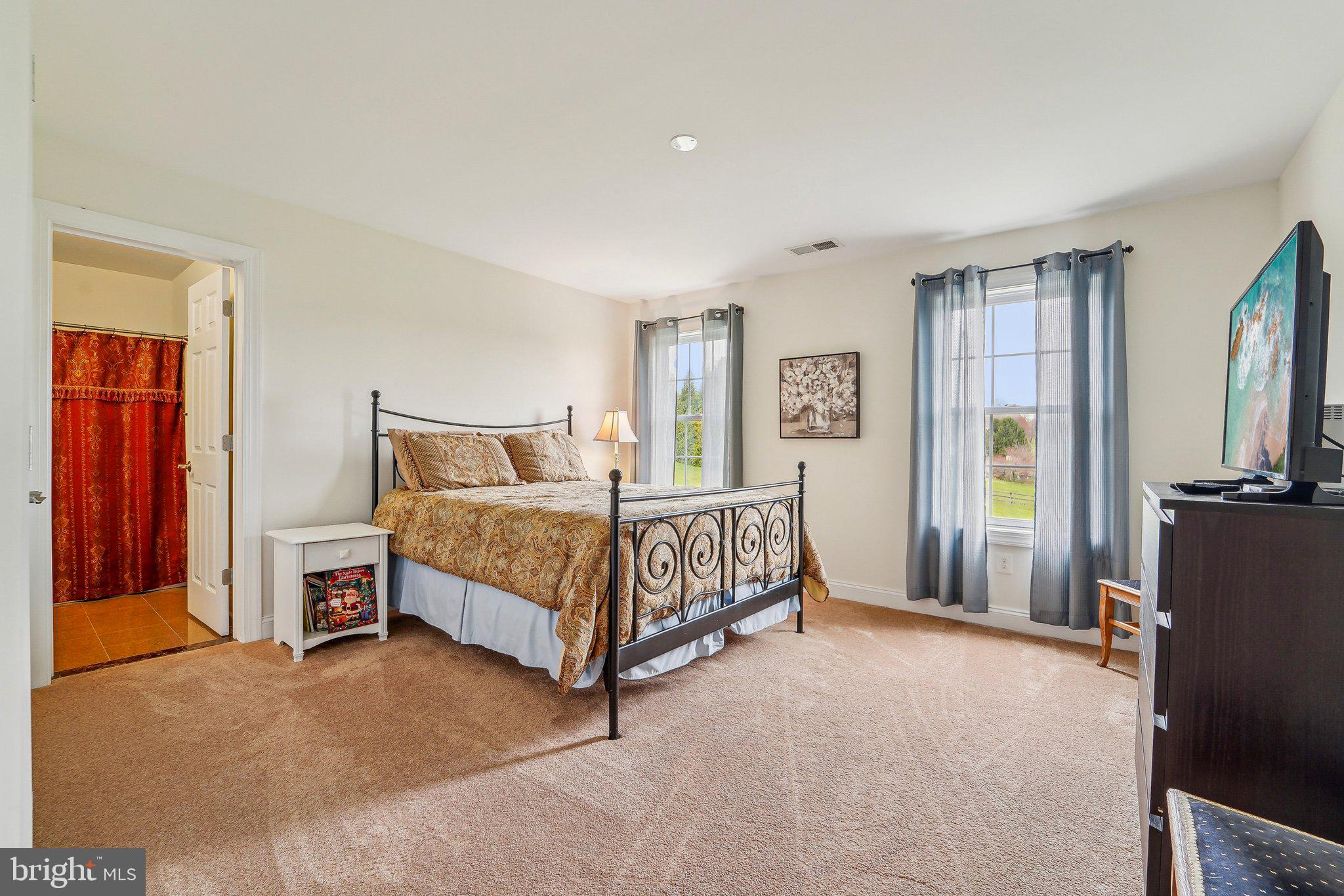 13936 Rover Mill Road West Friendship, MD 21794 - Photo 25 of 73 a bedroom with a bed and a chandelier