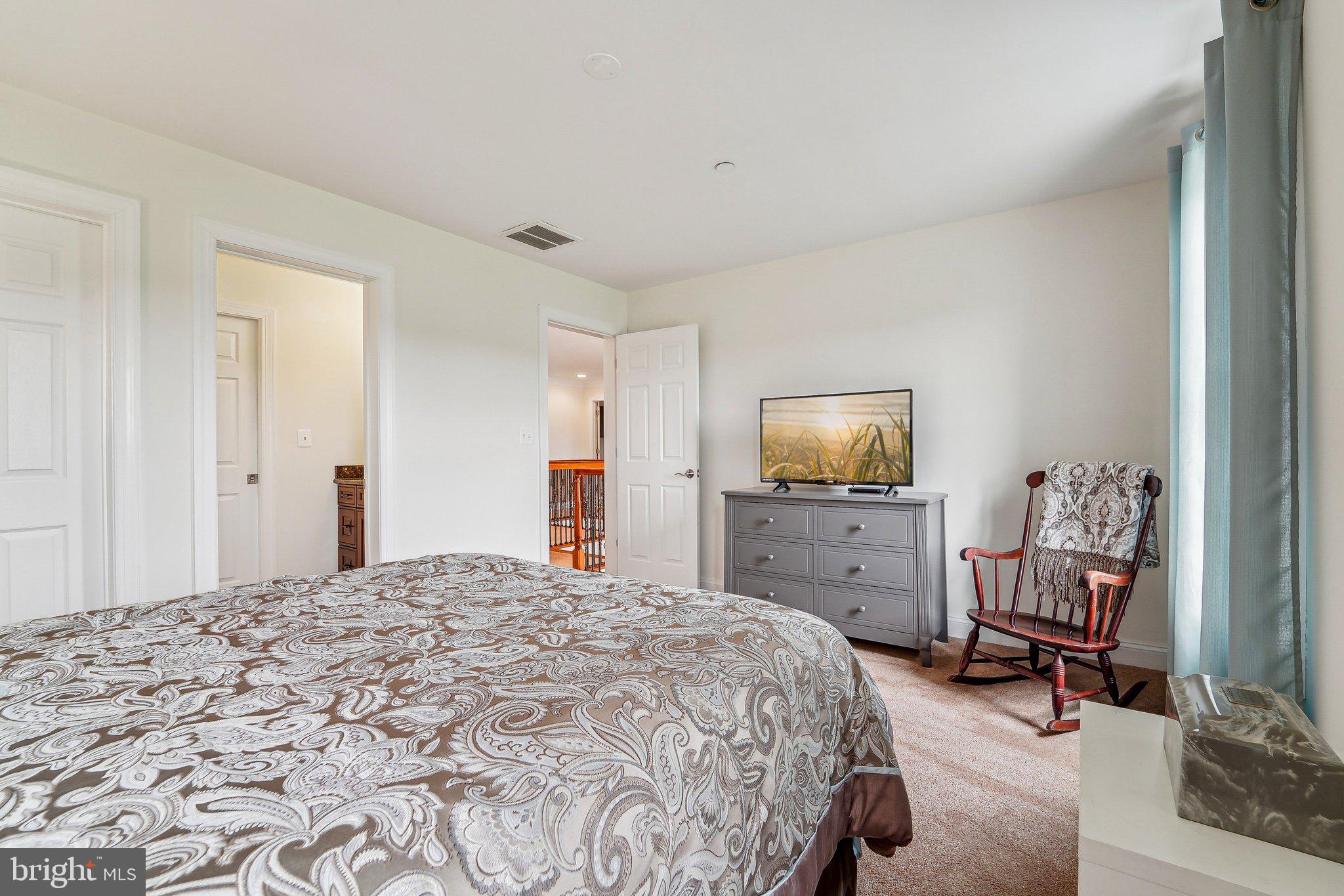 13936 Rover Mill Road West Friendship, MD 21794 - Photo 28 of 73 a bedroom with a bed and a chair in it