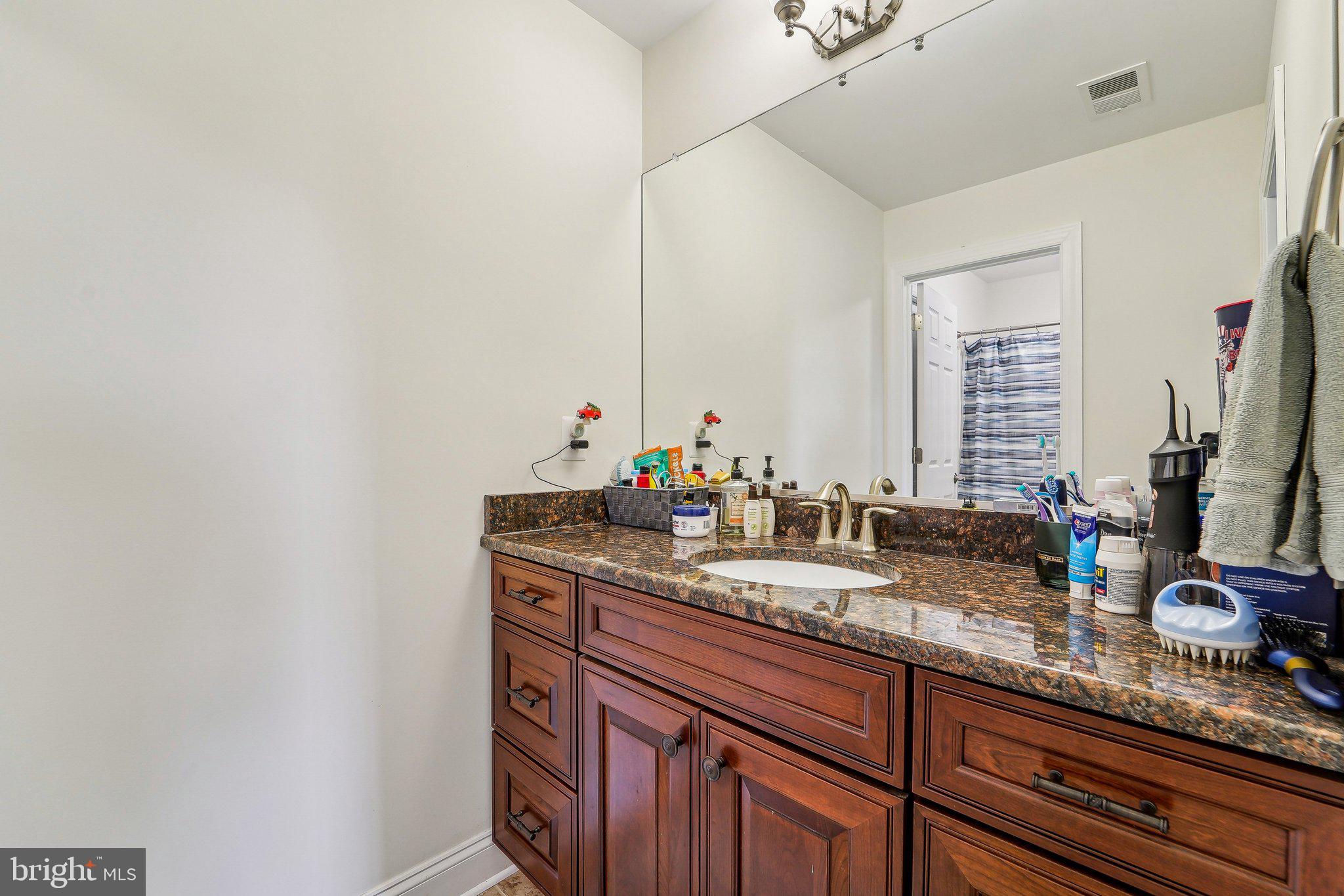 13936 Rover Mill Road West Friendship, MD 21794 - Photo 31 of 73 a bathroom with a granite countertop sink and a mirror