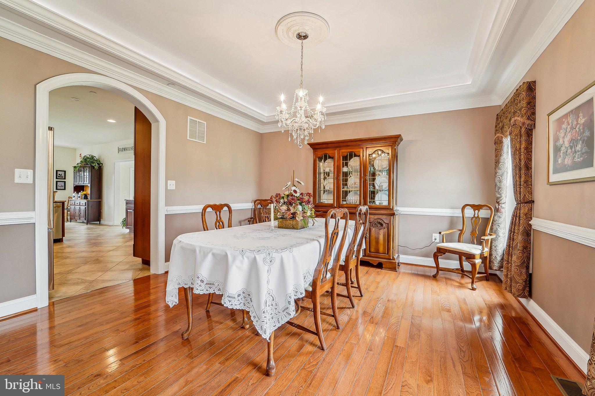 13936 Rover Mill Road West Friendship, MD 21794 - Photo 8 of 73 a view of a dining room with furniture a chandelier and wooden floor