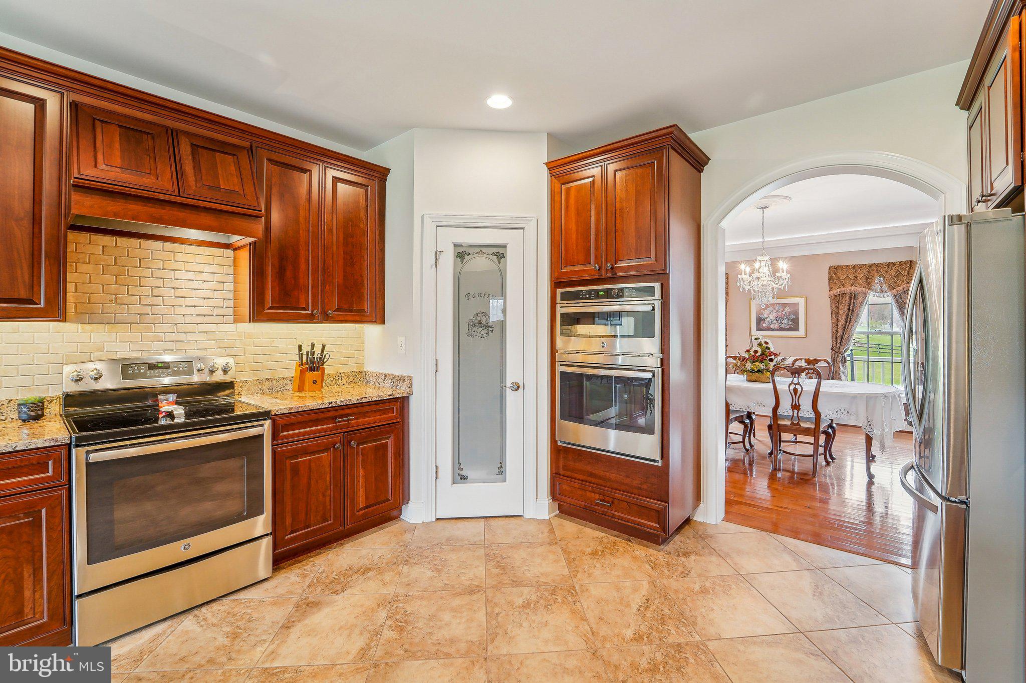 13936 Rover Mill Road West Friendship, MD 21794 - Photo 10 of 73 a kitchen with stainless steel appliances granite countertop a stove top oven and refrigerator