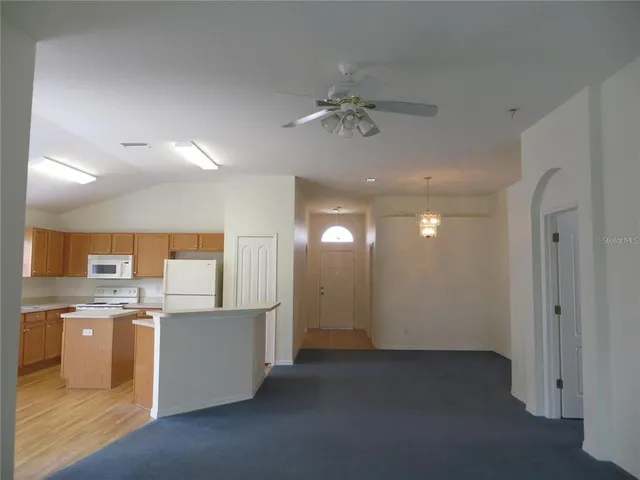 a view of a kitchen with a sink cabinets and stainless steel appliances