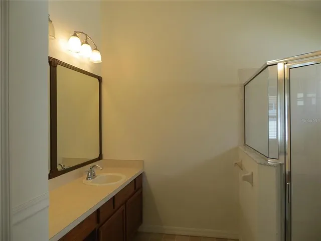 a bathroom with a glass shower door