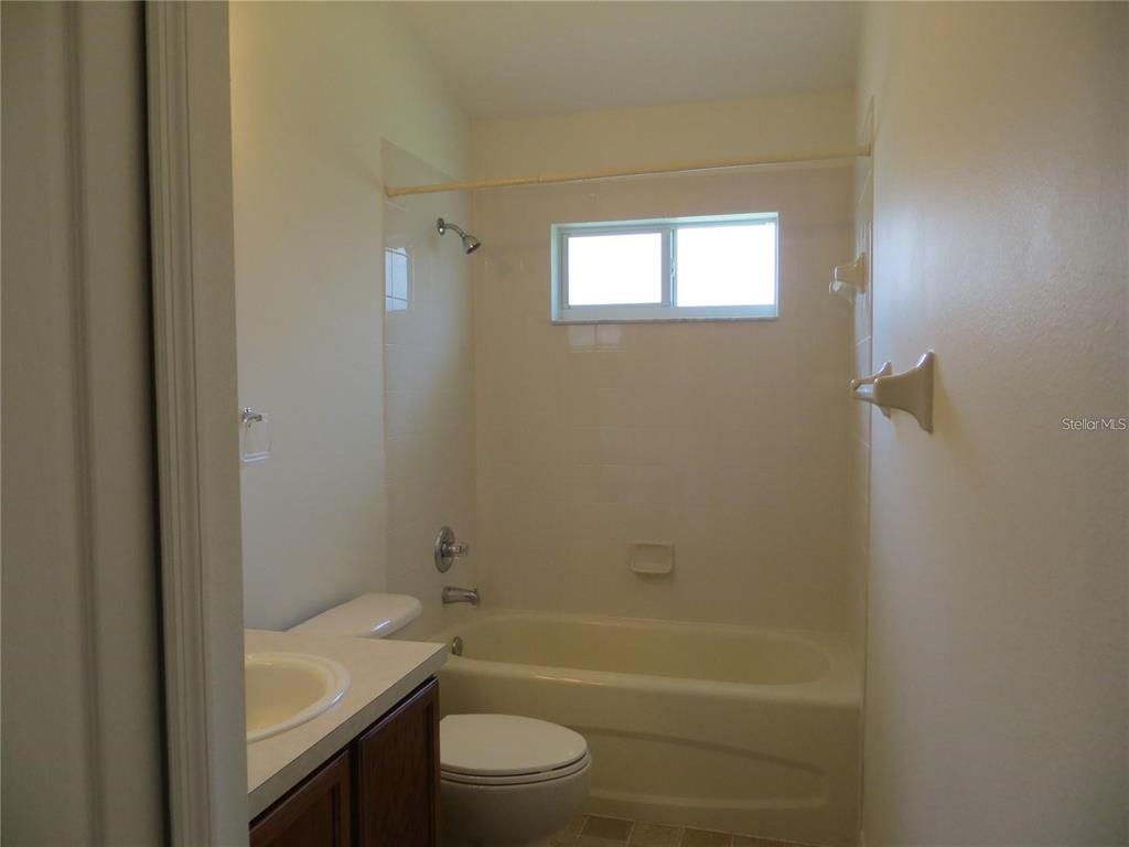 1012 Torreya Way Odessa, FL 33556 - Photo 36 of 40 a bathroom with a granite countertop bathtub shower sink vanity and toilet