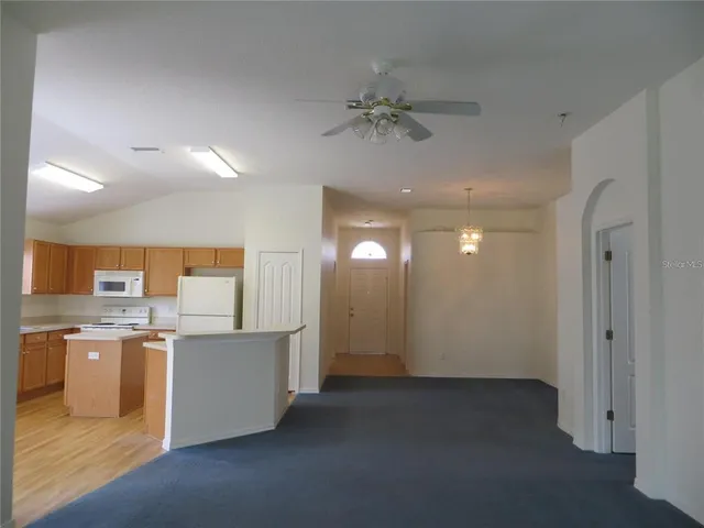 a view of a kitchen with a sink cabinets and wooden floor