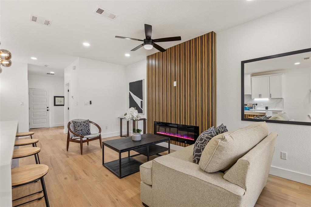 3526 Spring Avenue Dallas, TX 75210 - Photo 10 of 27 Living room featuring a glass covered fireplace, light wood finished floors, a ceiling fan, and recessed lighting