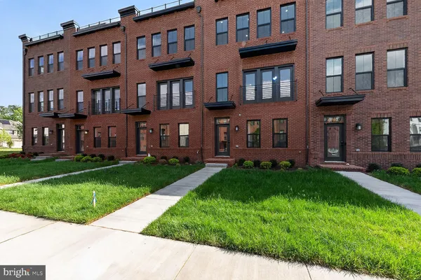 a view of a brick building next to a yard