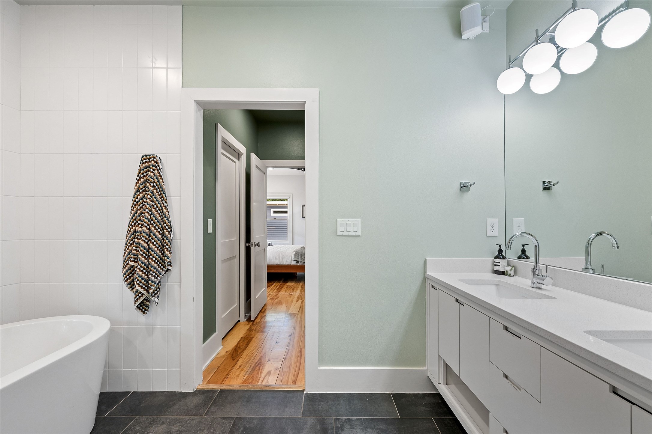 2000 Rundell Place Austin, TX 78704 - Photo 25 of 38 Dual vanities with sleek fixtures and a freestanding tub create a luxurious bathing experience.