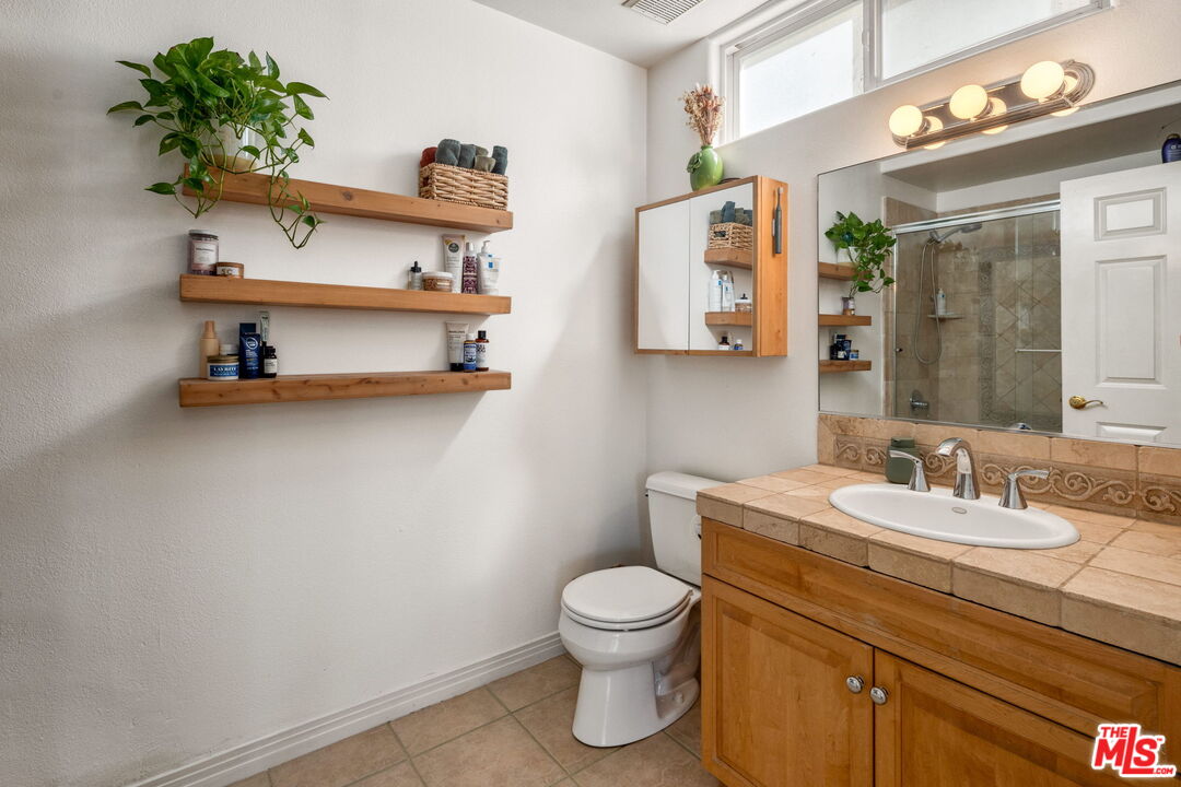 4400 Cartwright Avenue, Unit 102 North Hollywood, CA 91602 - Photo 15 of 21 a bathroom with a toilet sink and mirror