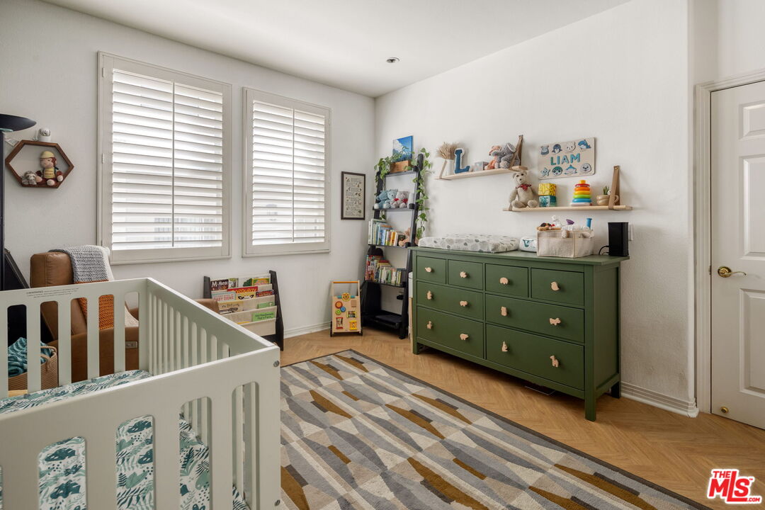 4400 Cartwright Avenue, Unit 102 North Hollywood, CA 91602 - Photo 17 of 21 a bedroom with furniture and a window
