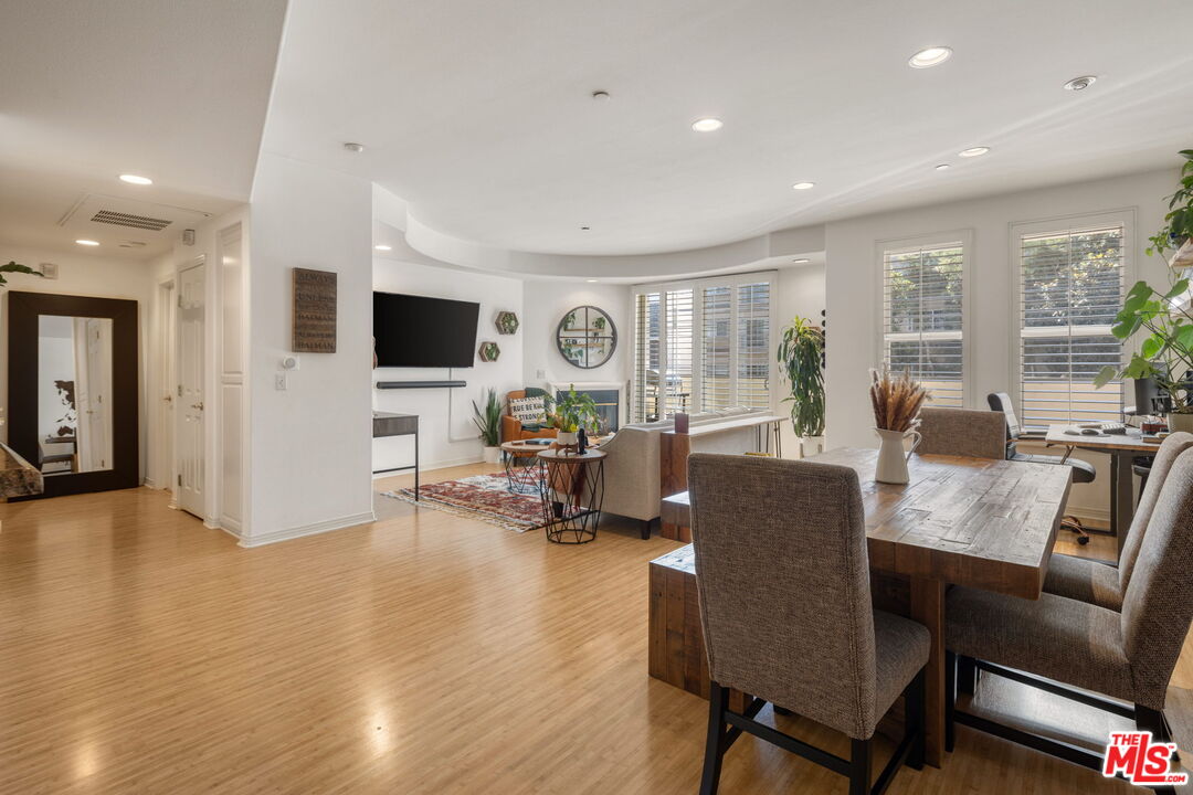 4400 Cartwright Avenue, Unit 102 North Hollywood, CA 91602 - Photo 3 of 21 a living room with fireplace furniture and a flat screen tv