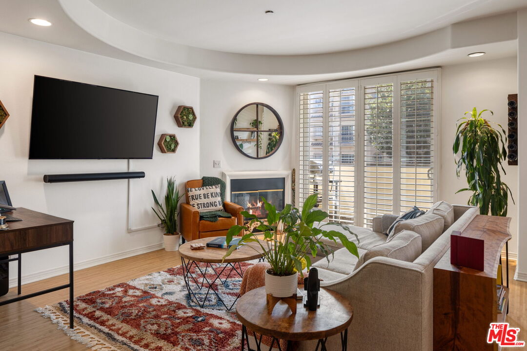 4400 Cartwright Avenue, Unit 102 North Hollywood, CA 91602 - Photo 6 of 21 a living room with furniture and a flat screen tv