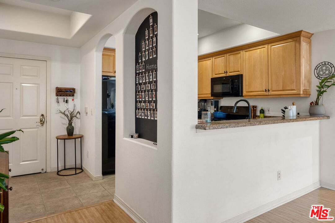 4400 Cartwright Avenue, Unit 102 North Hollywood, CA 91602 - Photo 8 of 21 a kitchen with stainless steel appliances a refrigerator sink and microwave
