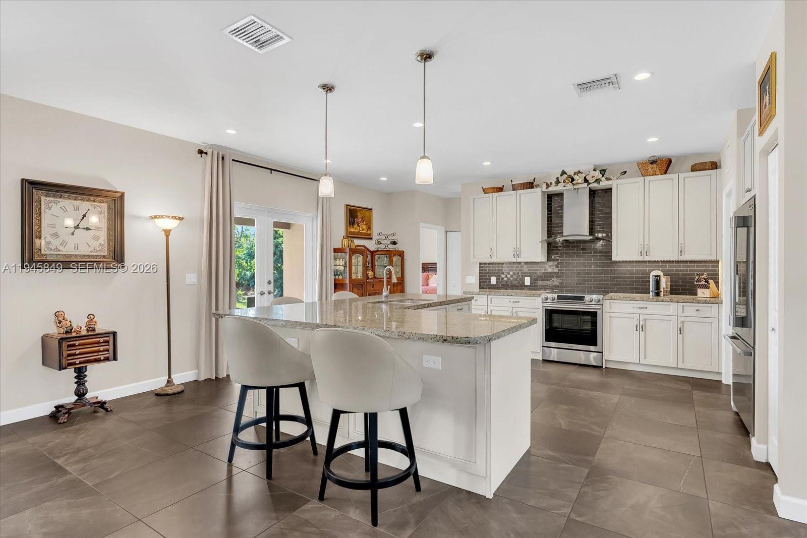 15150 Southwest 240th Street Homestead, FL 33032 - Photo 11 of 38 a kitchen with stainless steel appliances kitchen island granite countertop a sink and cabinets