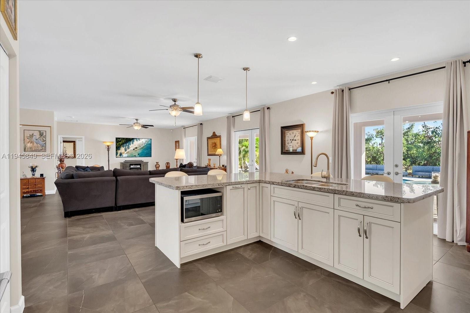 15150 Southwest 240th Street Homestead, FL 33032 - Photo 13 of 38 a kitchen with stove a sink and cabinets