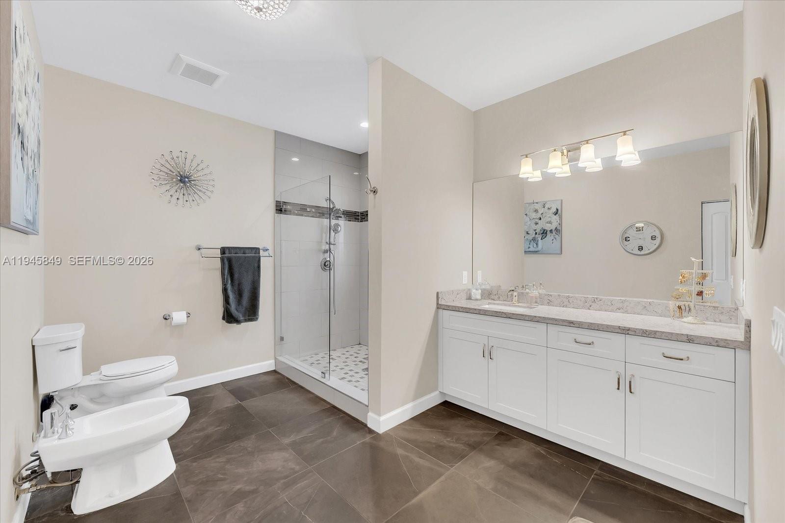 15150 Southwest 240th Street Homestead, FL 33032 - Photo 17 of 38 a bathroom with a double vanity sink toilet and shower