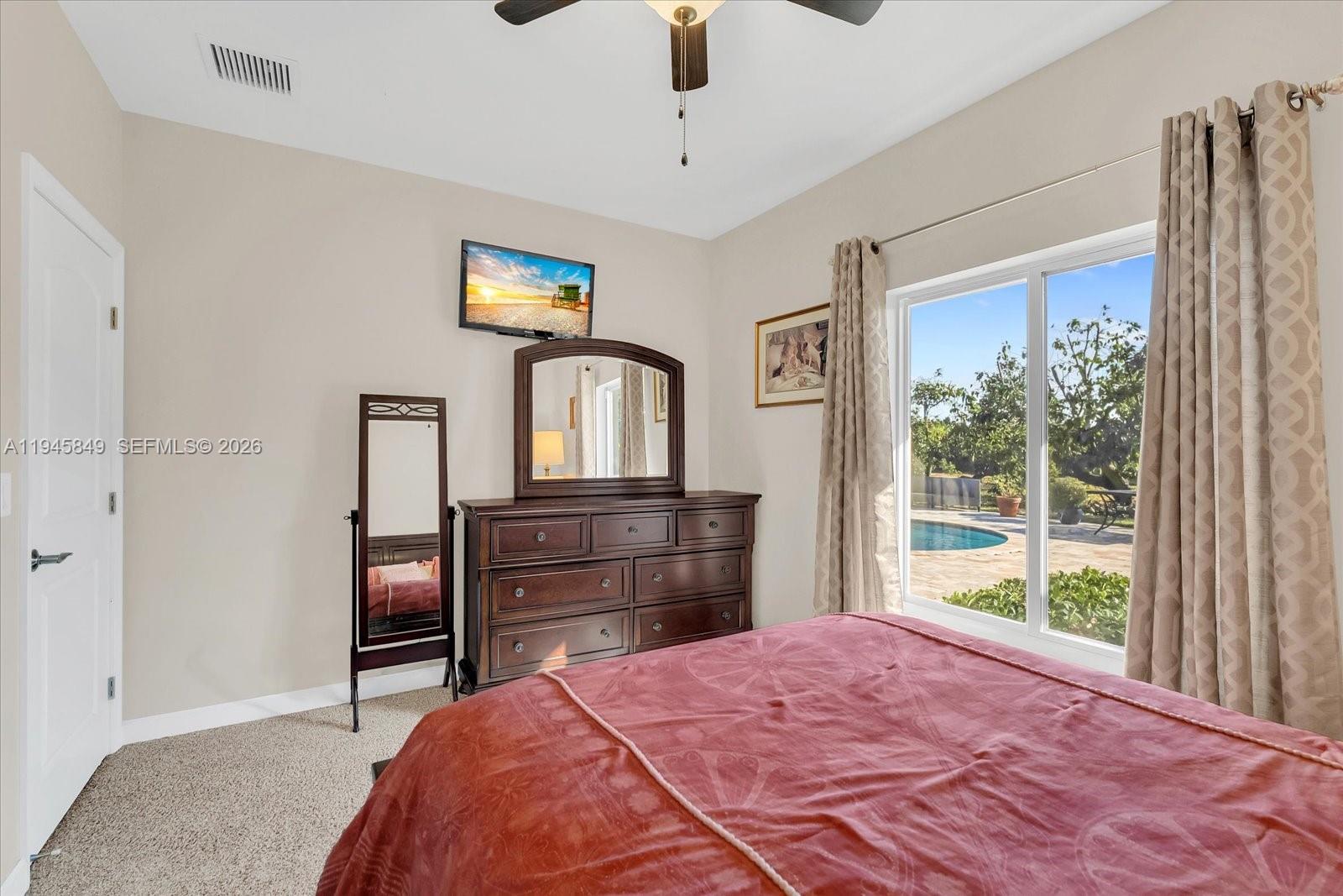 15150 Southwest 240th Street Homestead, FL 33032 - Photo 21 of 38 a bedroom with a bed and a dresser