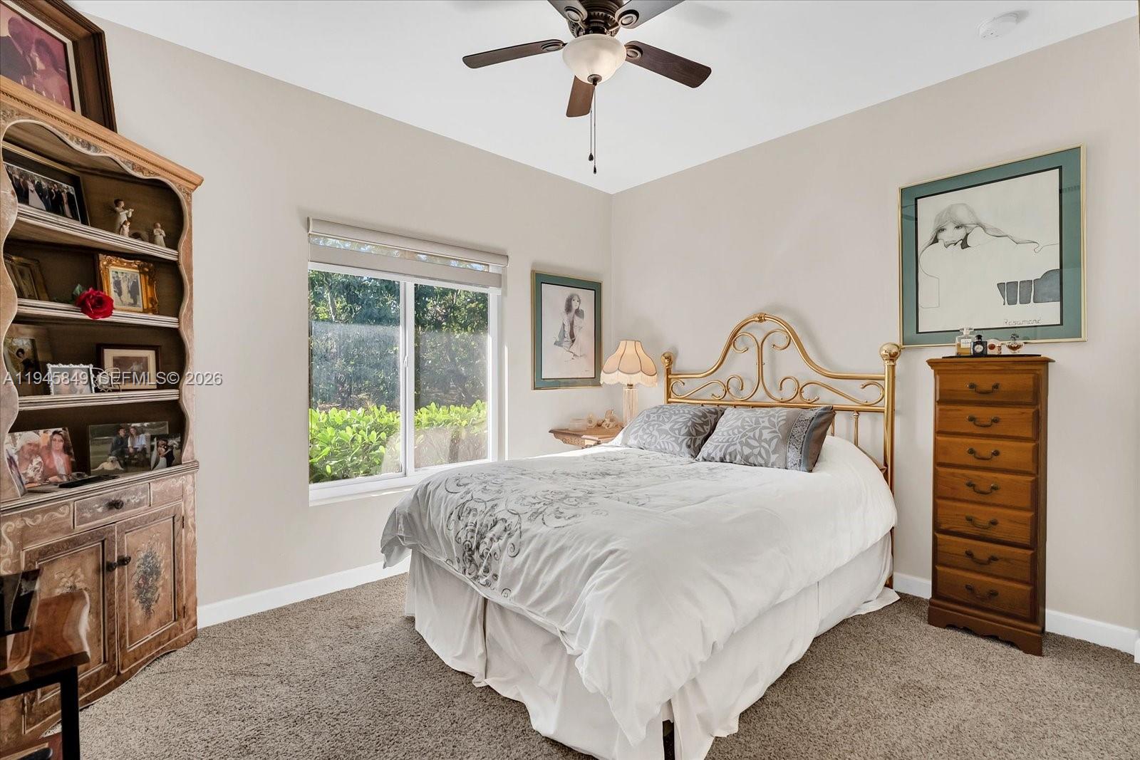 15150 Southwest 240th Street Homestead, FL 33032 - Photo 22 of 38 a bedroom with a bed a bookshelf and a painting on the wall