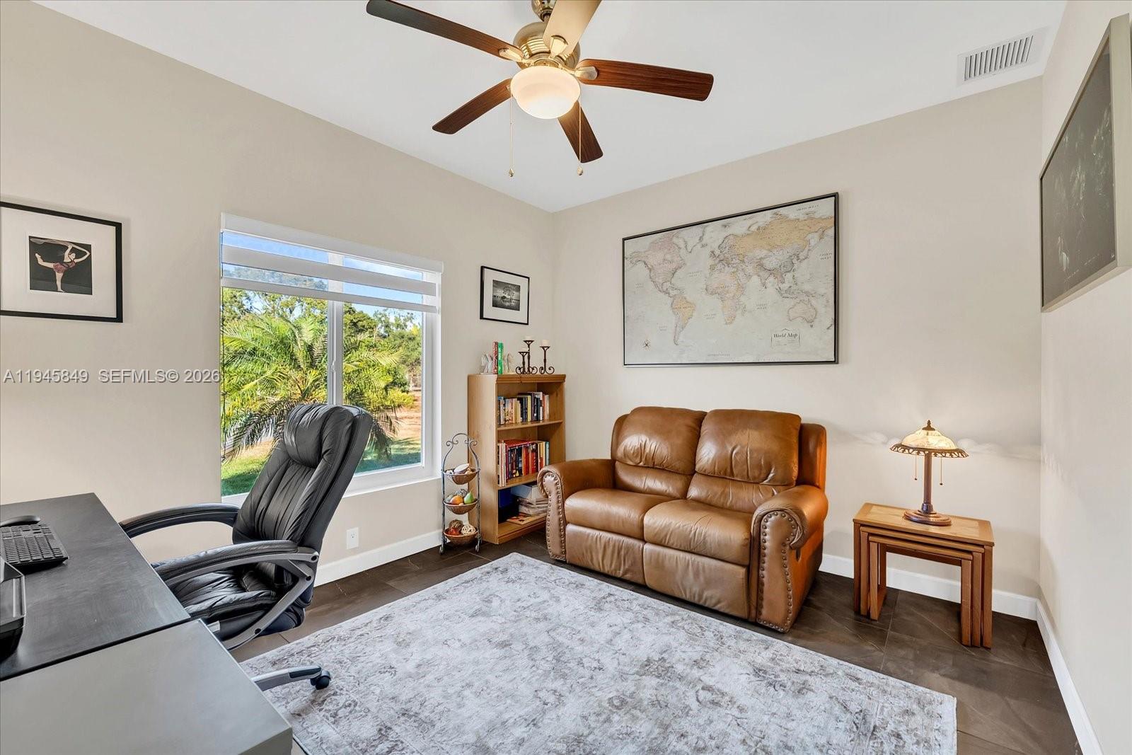 15150 Southwest 240th Street Homestead, FL 33032 - Photo 25 of 38 a living room with furniture ceiling fan and a window