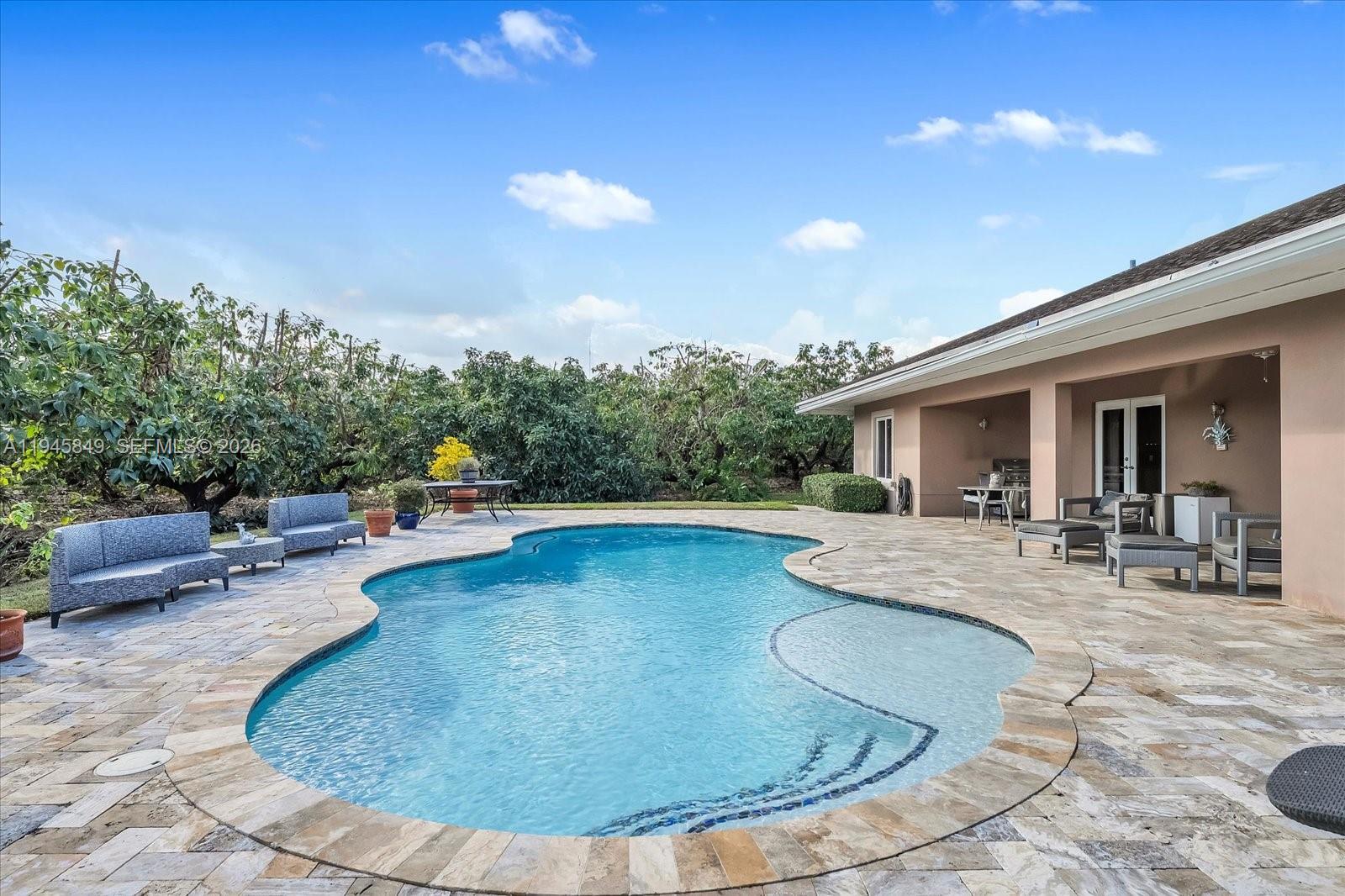15150 Southwest 240th Street Homestead, FL 33032 - Photo 29 of 38 a view of a swimming pool with sitting area