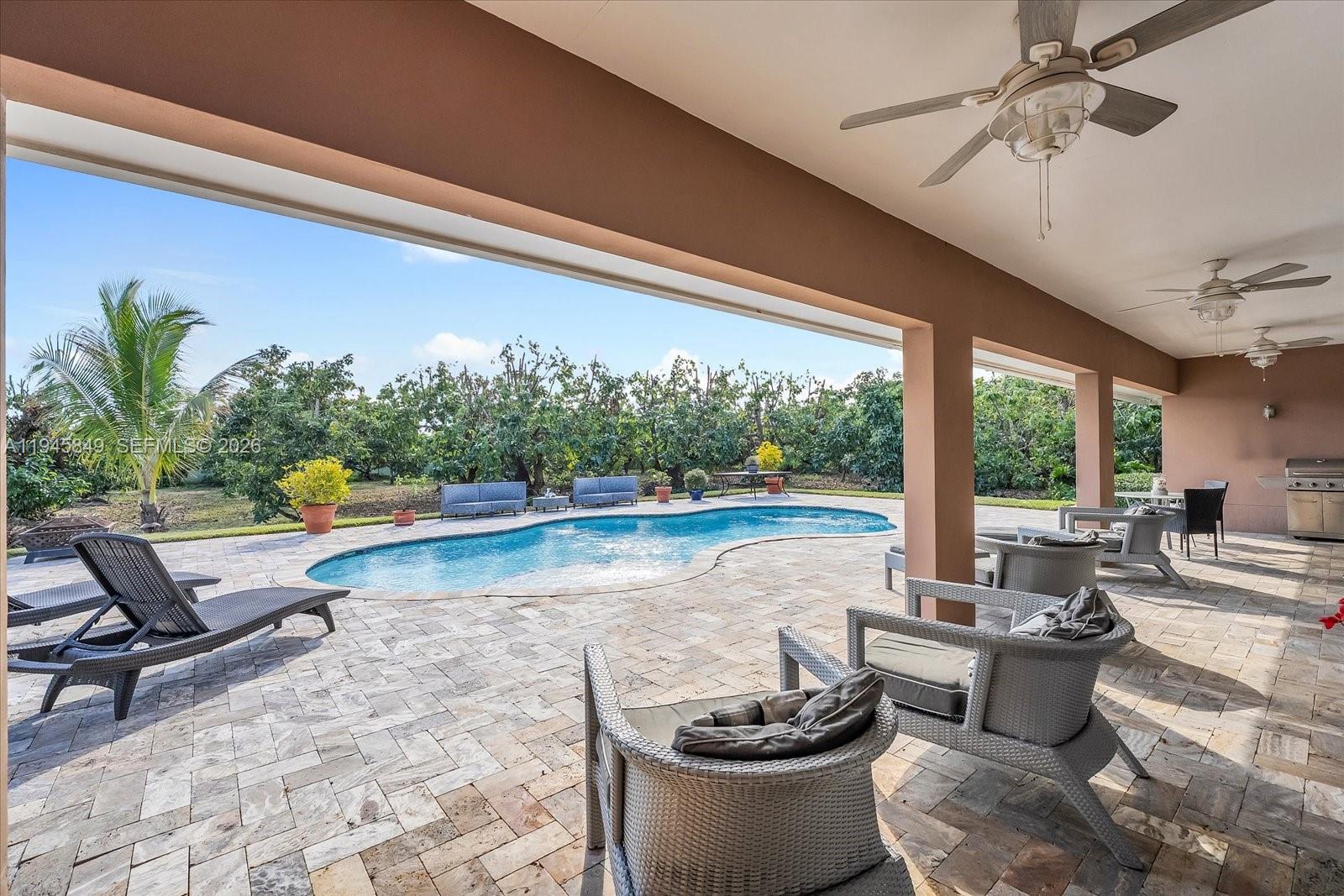 15150 Southwest 240th Street Homestead, FL 33032 - Photo 30 of 38 a living room with furniture and a large window