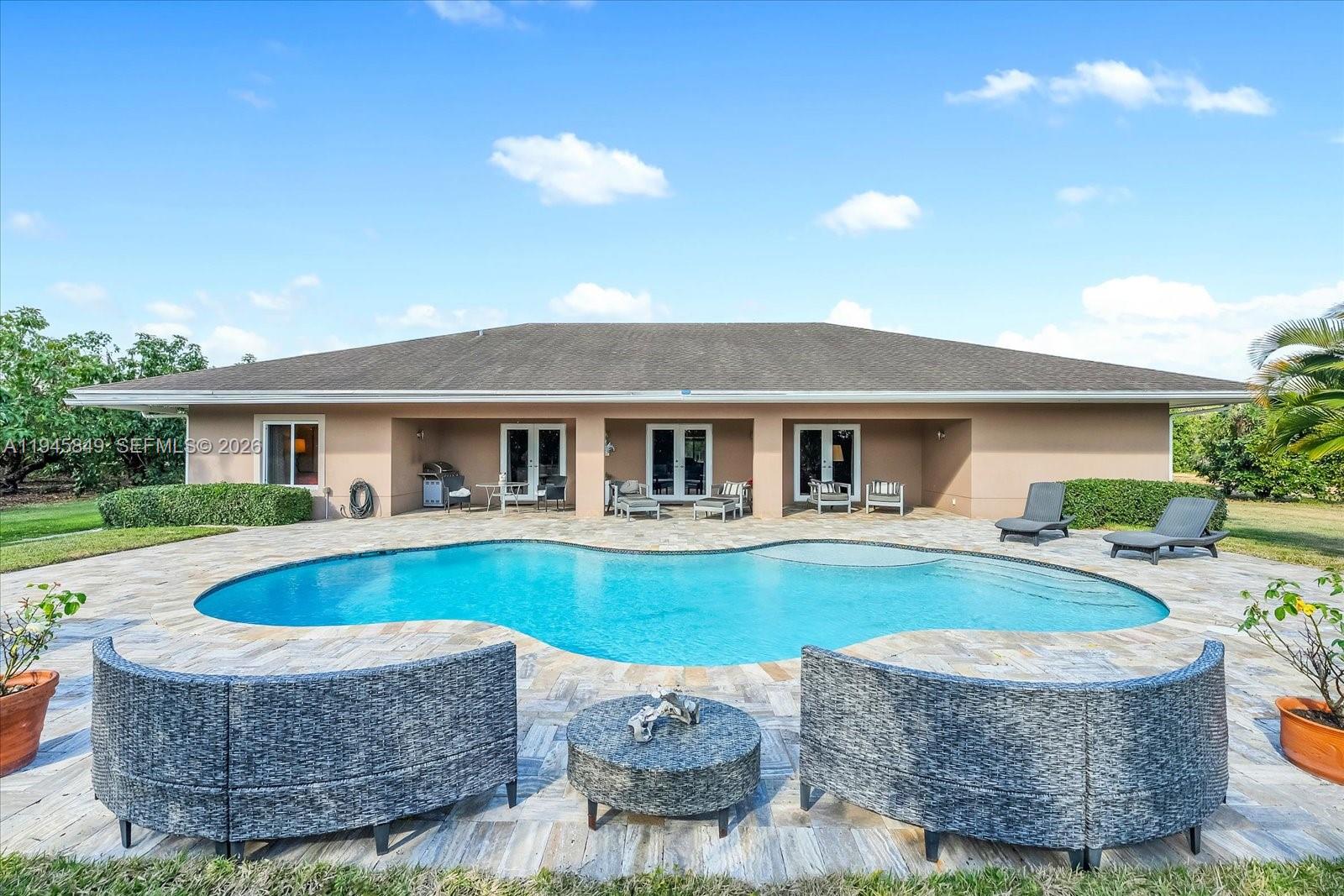 15150 Southwest 240th Street Homestead, FL 33032 - Photo 3 of 38 a view of house with swimming pool and a yard