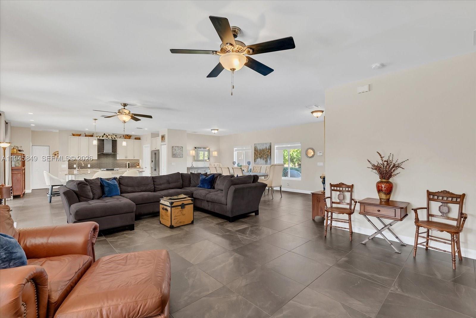 15150 Southwest 240th Street Homestead, FL 33032 - Photo 6 of 38 a living room with furniture kitchen view and a chandelier