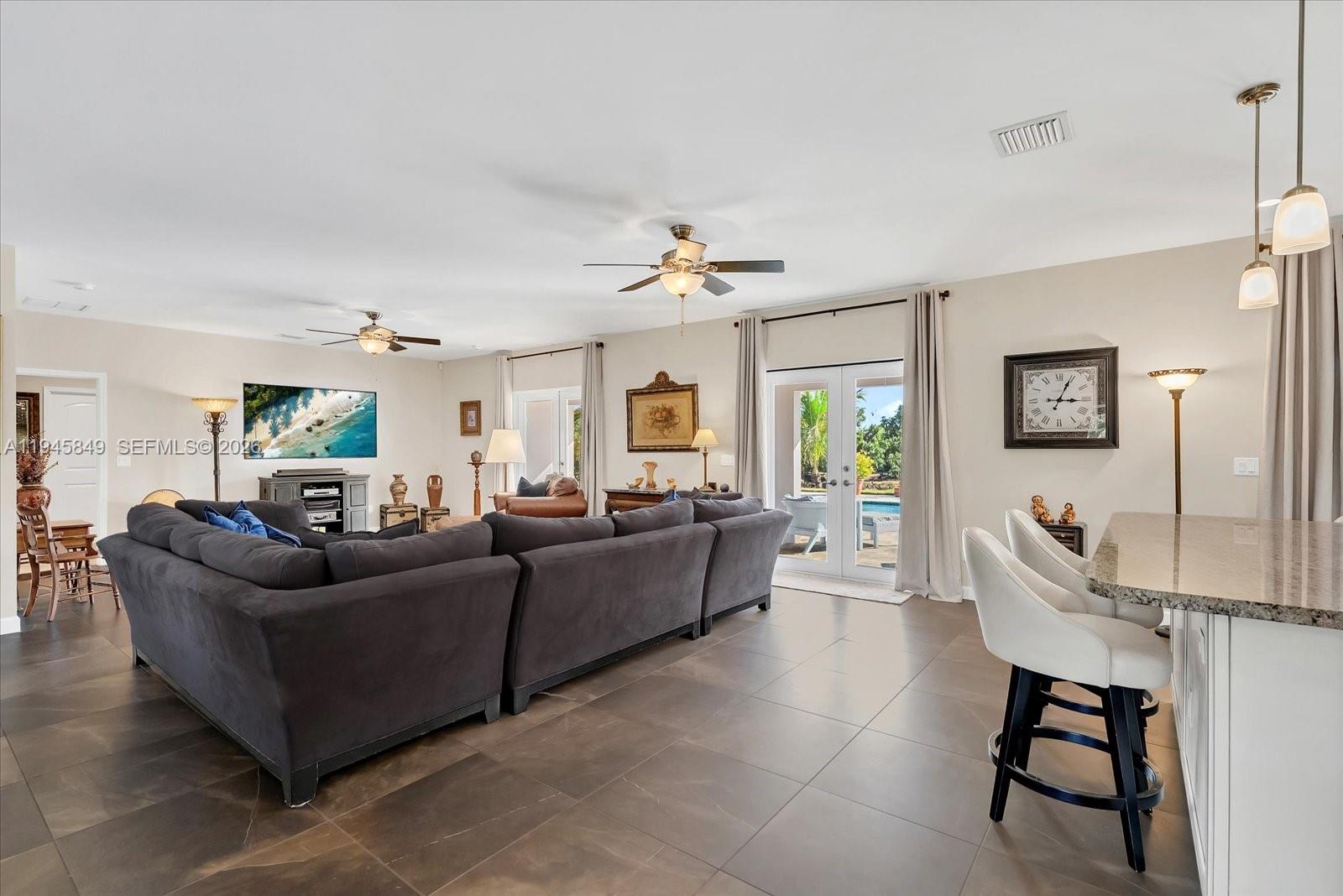 15150 Southwest 240th Street Homestead, FL 33032 - Photo 7 of 38 a living room with furniture and a window